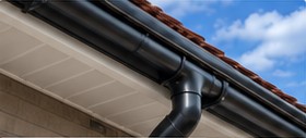 Black guttering and downpipe