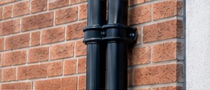 Soil stack pipework on a brick wall